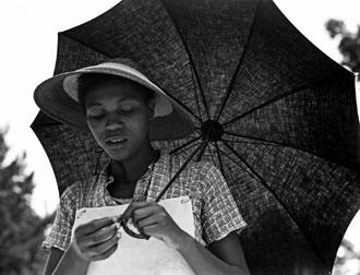 "Girl with umbrella (Louisiana negress)" (Dorothea Lange, 1937)